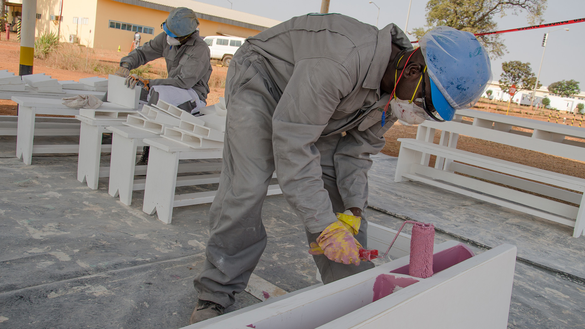 Employees of EEPCI contractor SENEV Tchad finishing a set of desks for local villages