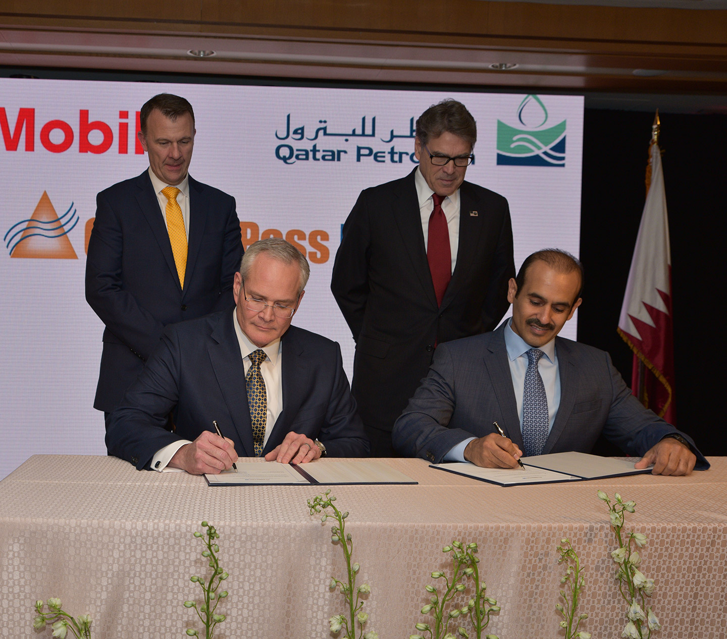 ExxonMobil Chairman and CEO Darren Woods and Qatar Petroleum President and CEO H.E. Saad Al-Kaabi sign agreement to proceed with construction of the Golden Pass LNG export facility as United States Energy Secretary Rick Perry and Golden Pass Products CEO Sean Ryan look on.