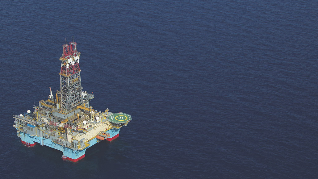 Aerial view of ExxonMobil oil rig in the ocean.