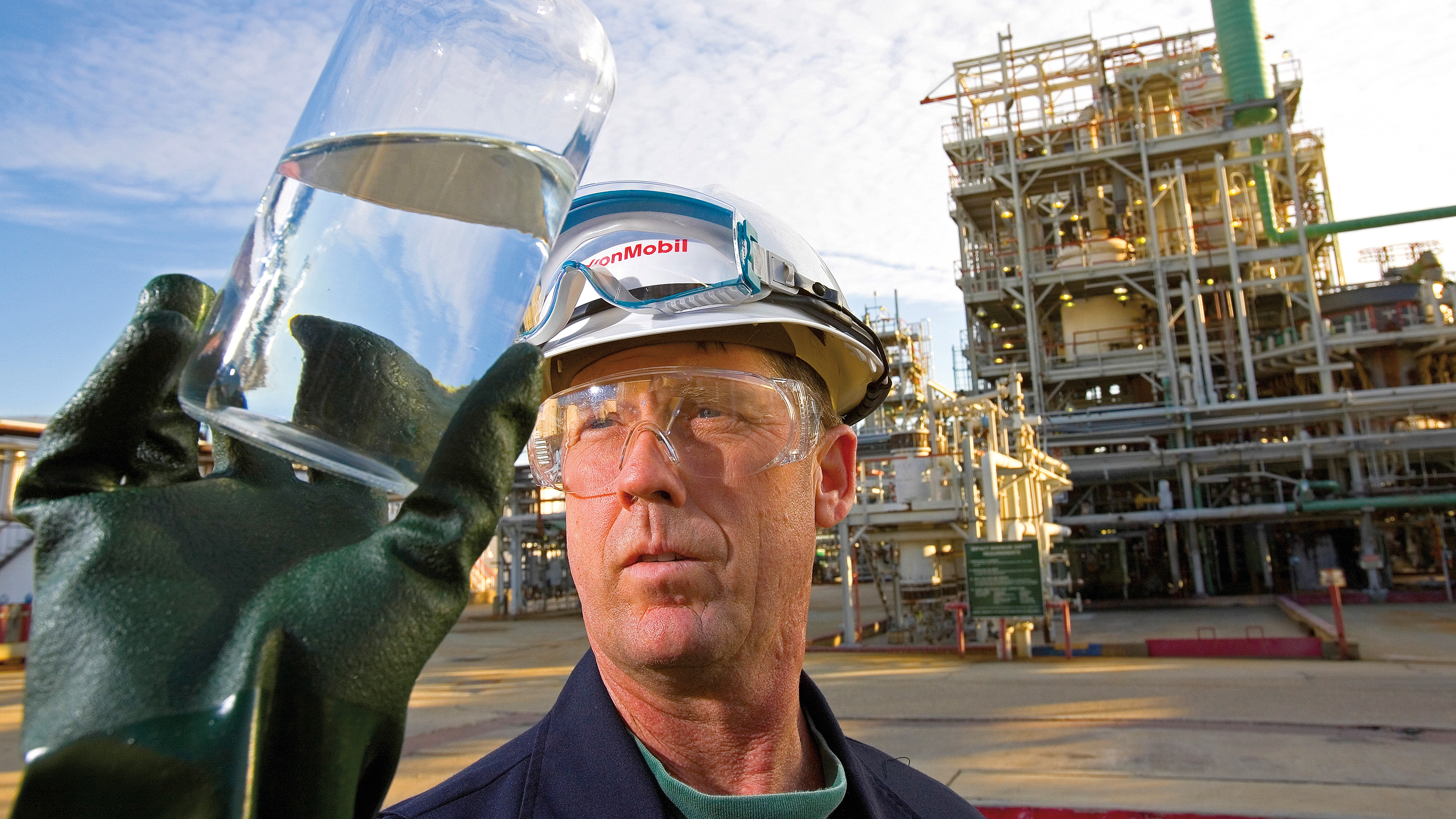 Chemical plant worker inspecting bottle
