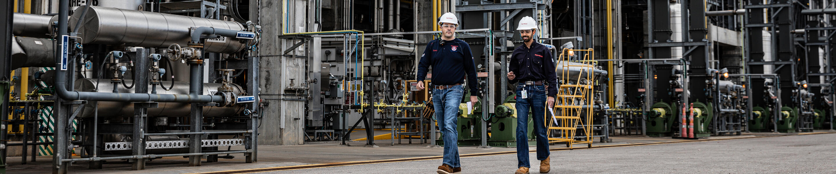 ExxonMobil employees walking in the Baytown, Texas refinery.