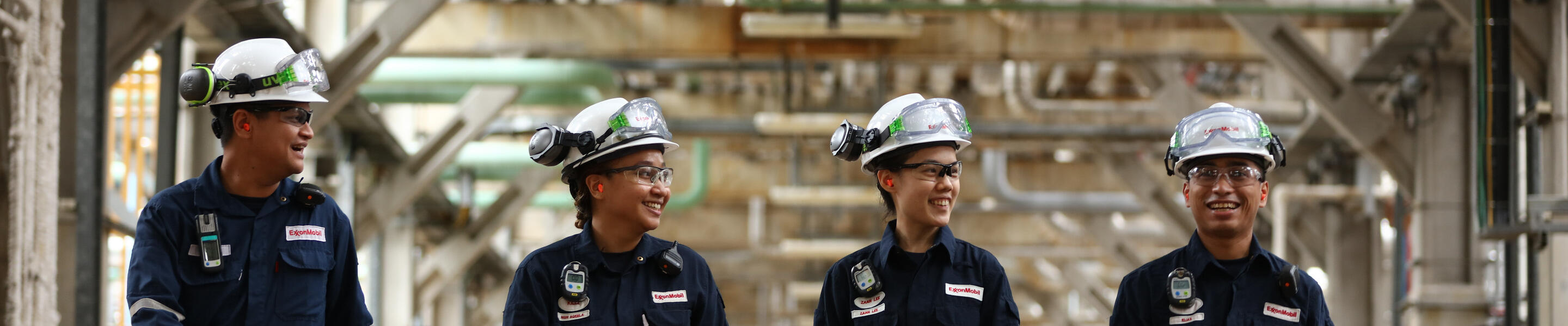employees in protective gear walking through HDS pump lane