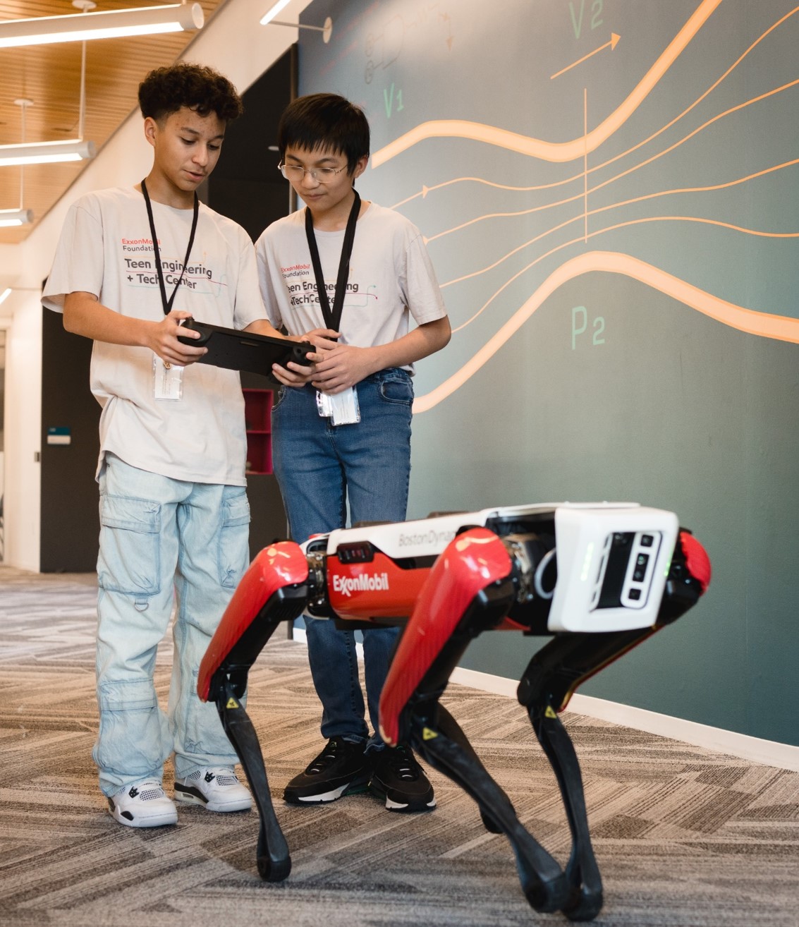 Students operate a robot at the Spring TETC