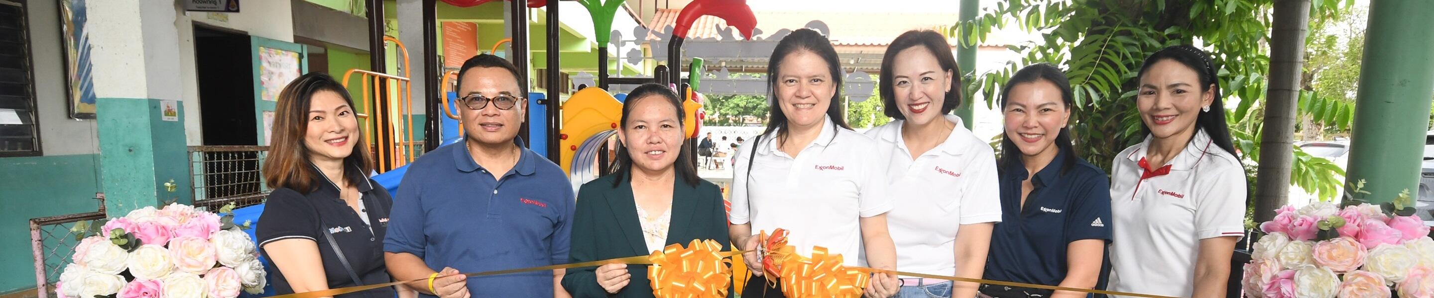 Suda Ninvoraskul, managing director of ExxonMobil Limited cut the ribbon to open the new playground with Sarinee Asa, Chumchon Wat Hatthasan Kaset school director.