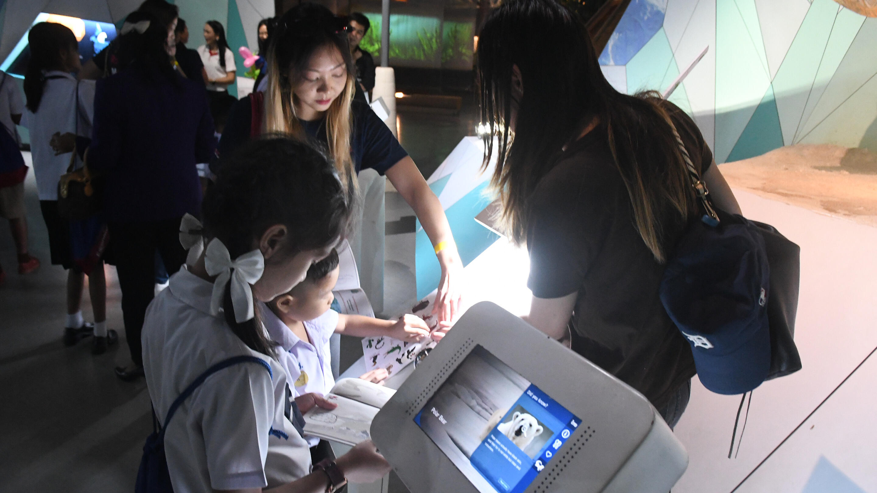 Employees taking students on a walk rally activity to explore the Rama IX Museum.
