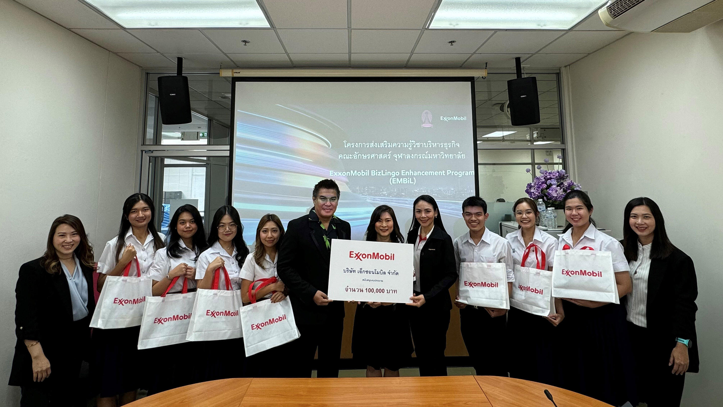 presenting 100,000 baht donation to university dean of students for the Arts