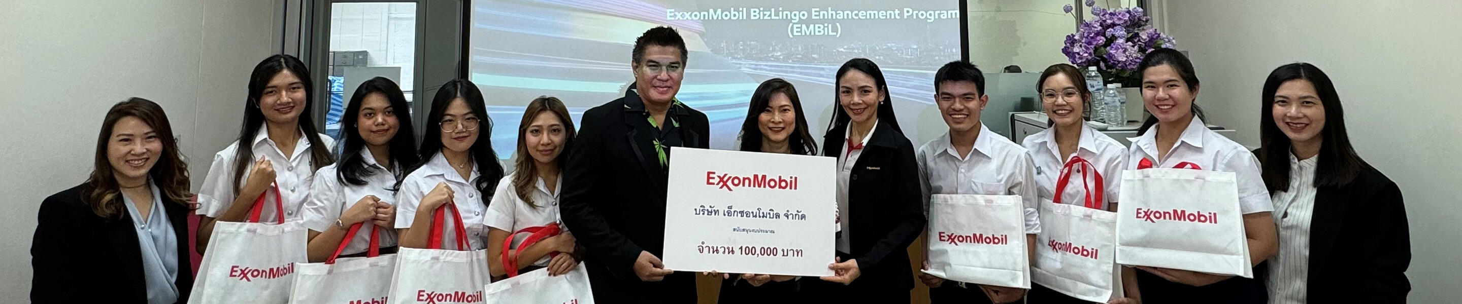 presenting 100,000 baht donation to university dean of students for the Arts