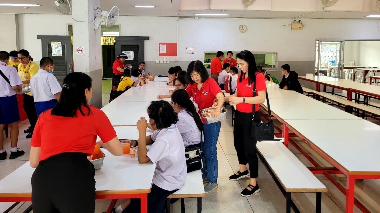 volunteers distributing snacks to individuals at the facility