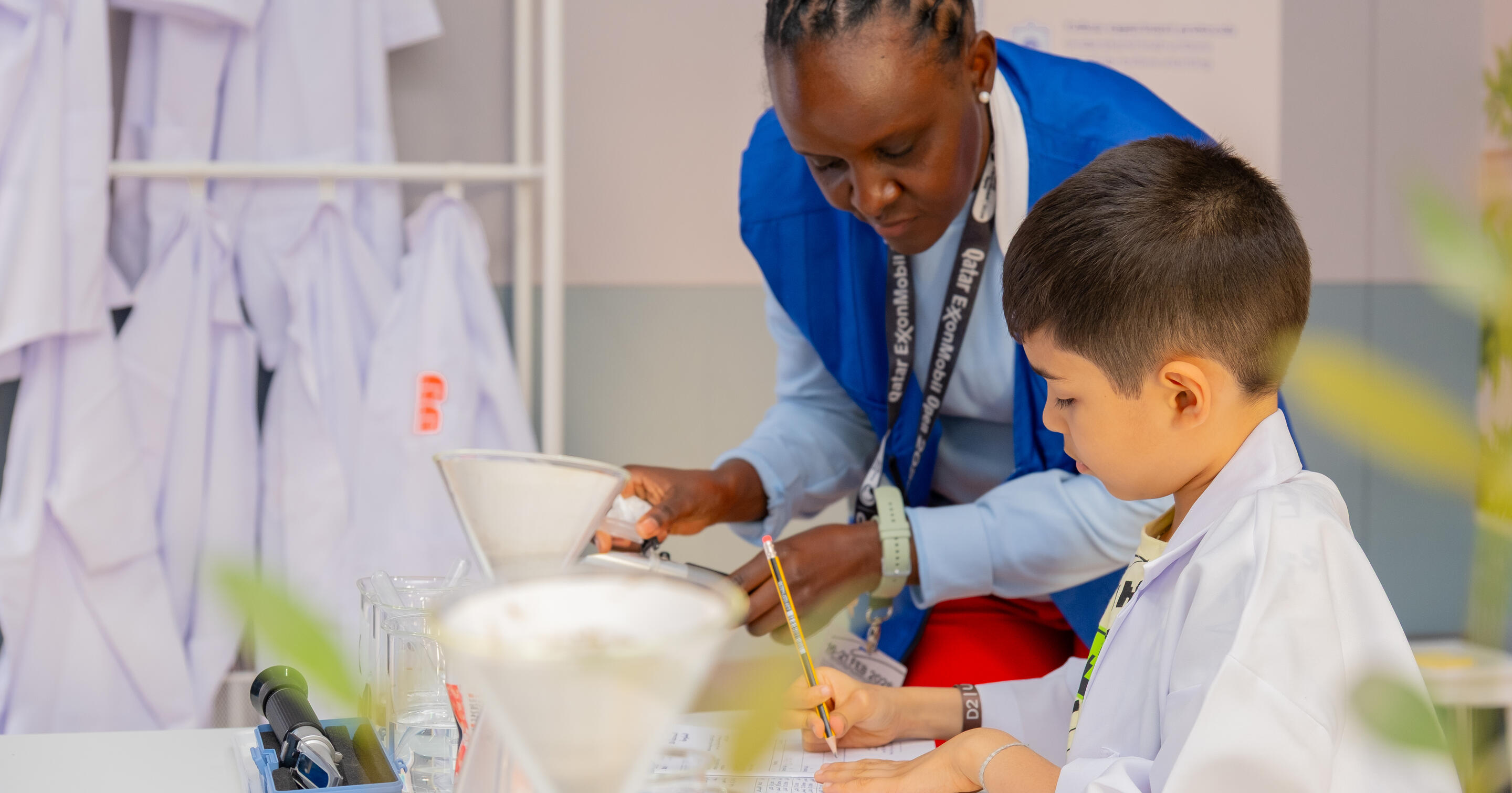 Children participate in salinity testing experiments, recording readings and observing how mangroves adapt to their environment