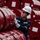 Worker handling a stack of red barrels