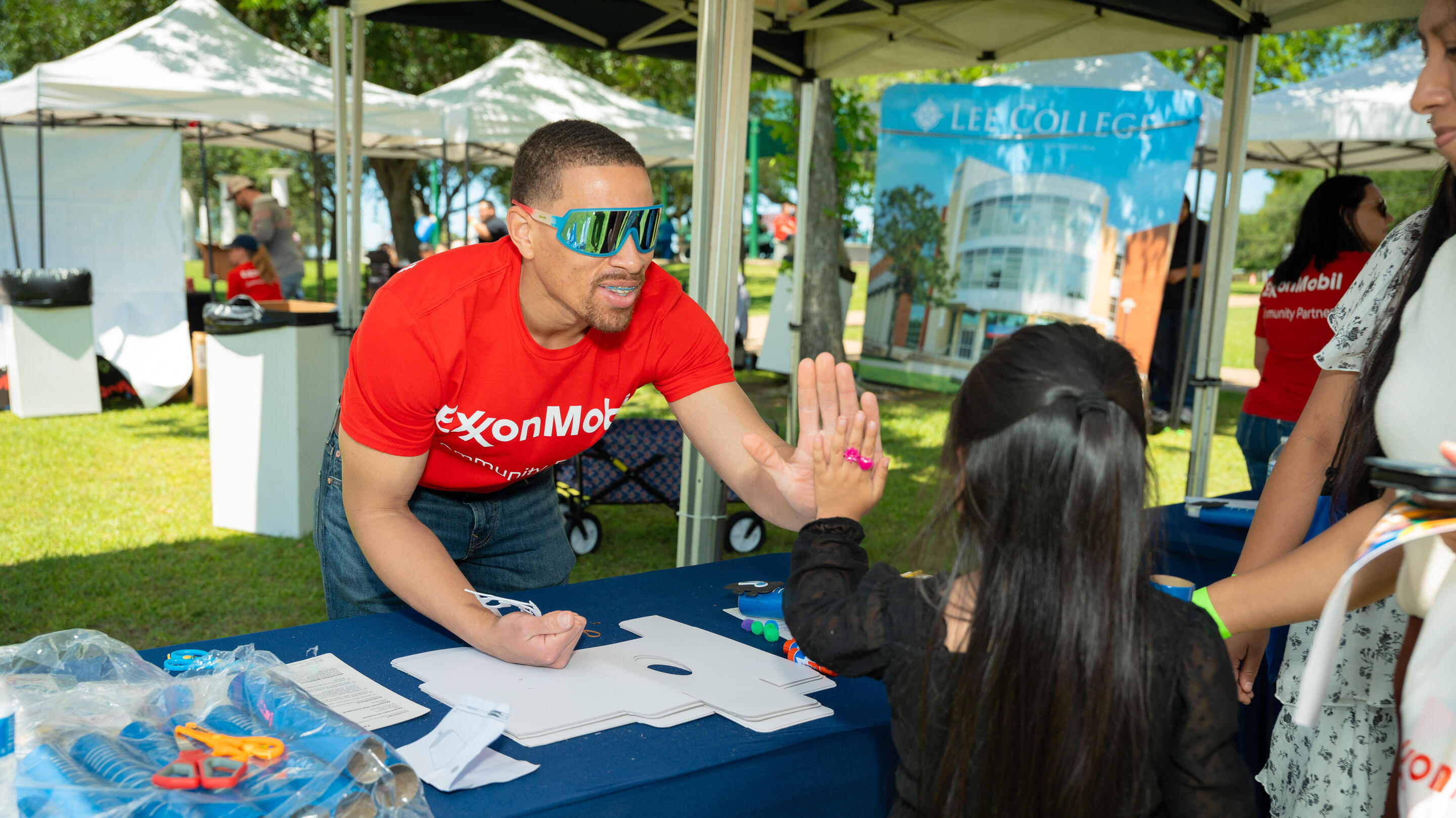 ExxonMobil employee Lorence Richard demonstrates a hands-on STEM activity with a student.