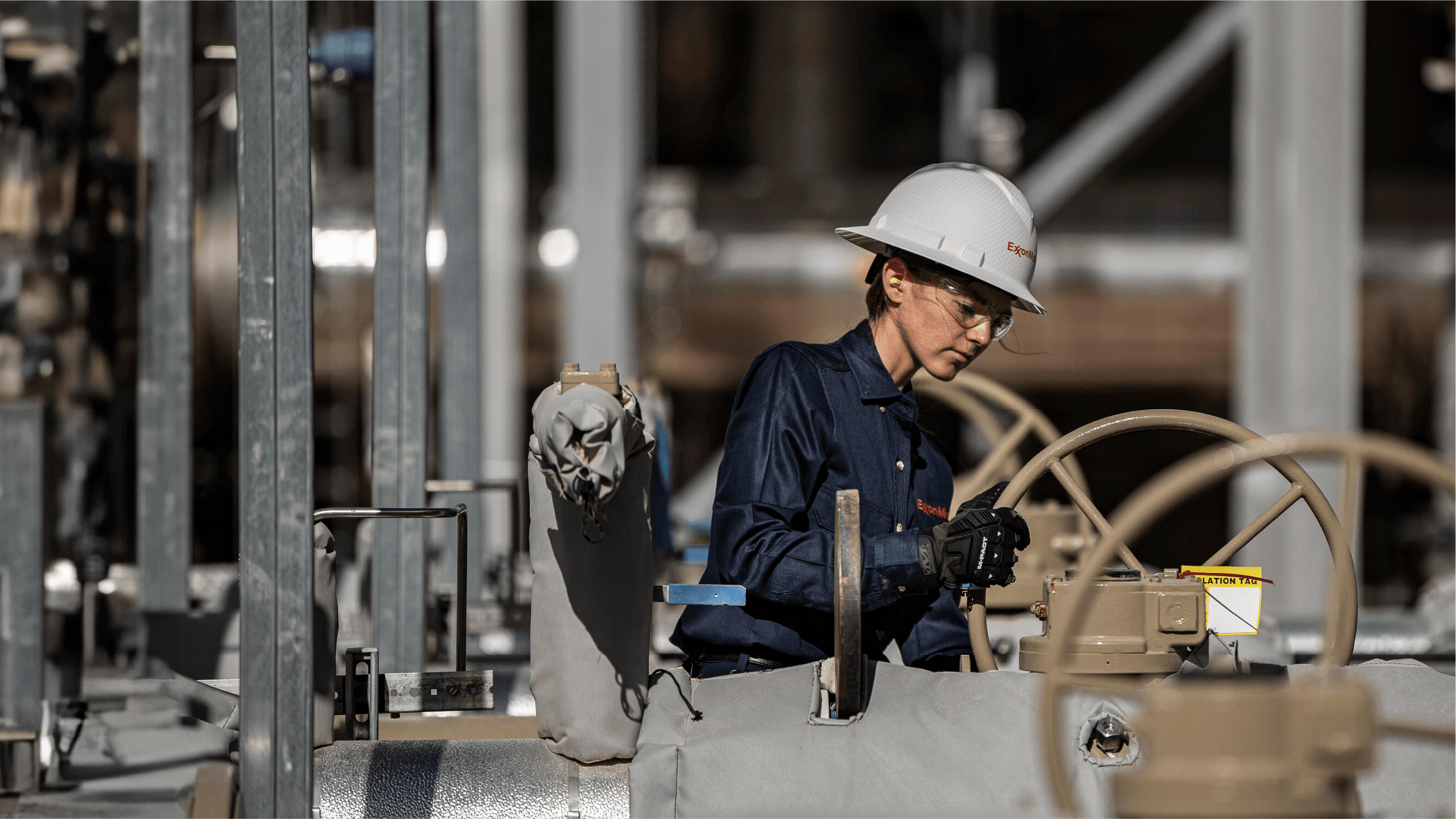 Female ExxonMobil employee working with pipelines