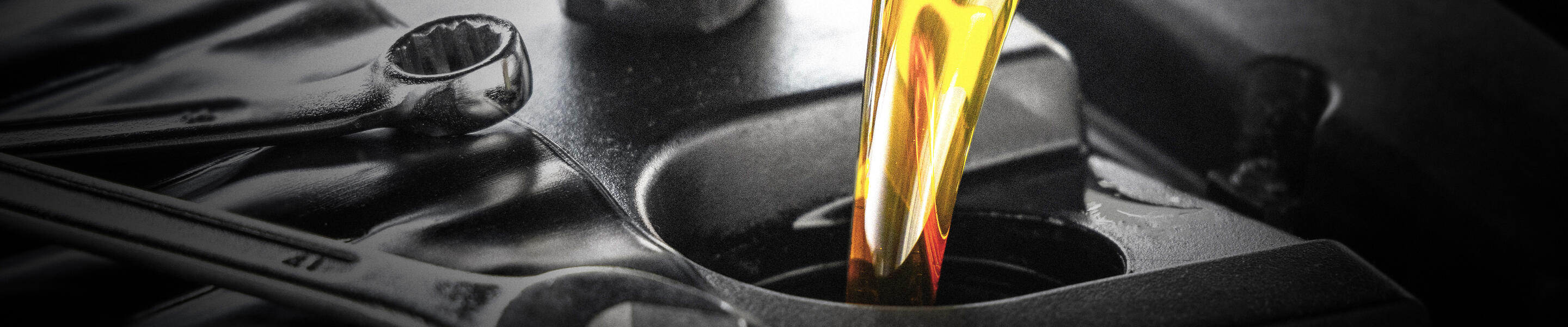 motor oil being poured into an engine