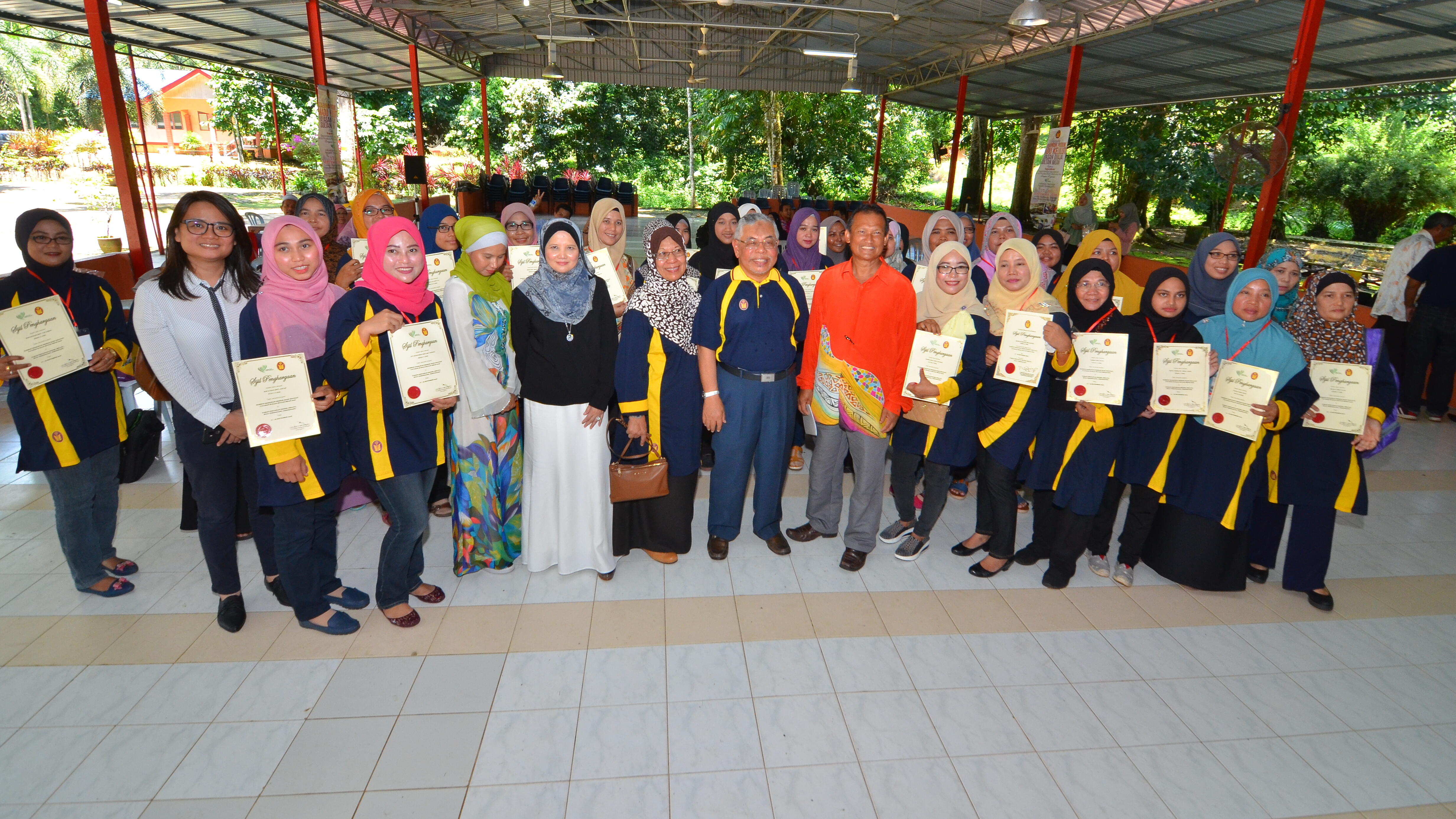 group of ExxonMobil Malaysia employees holding certificates