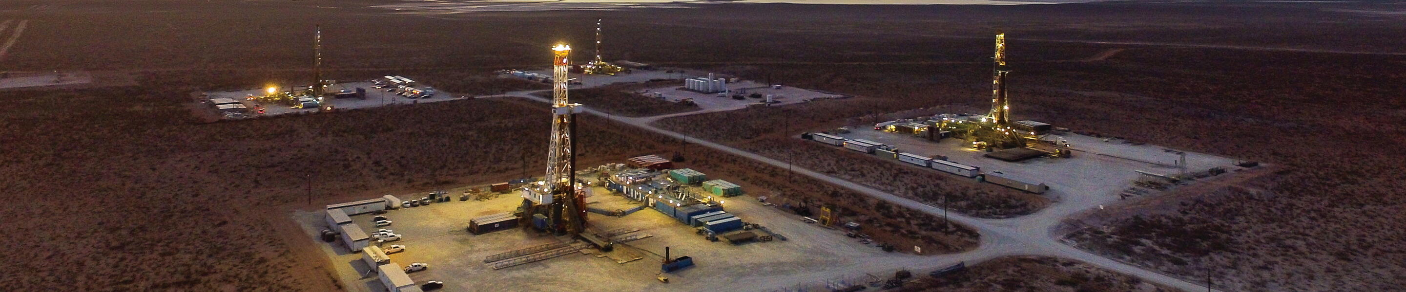 Oil rigs in New Mexico at dusk.