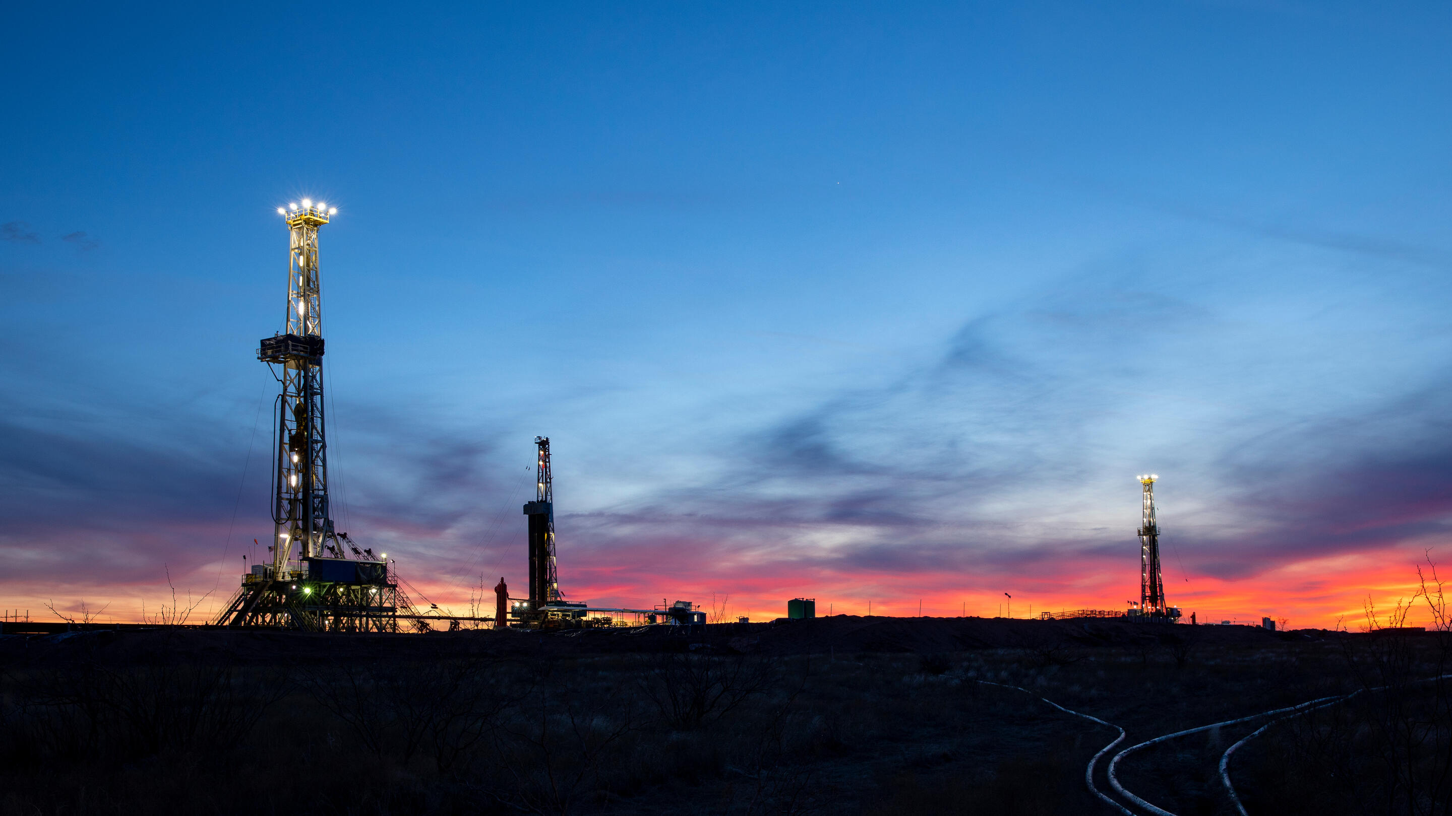 Operations in the Permian Basin near Midland, Texas at dusk.