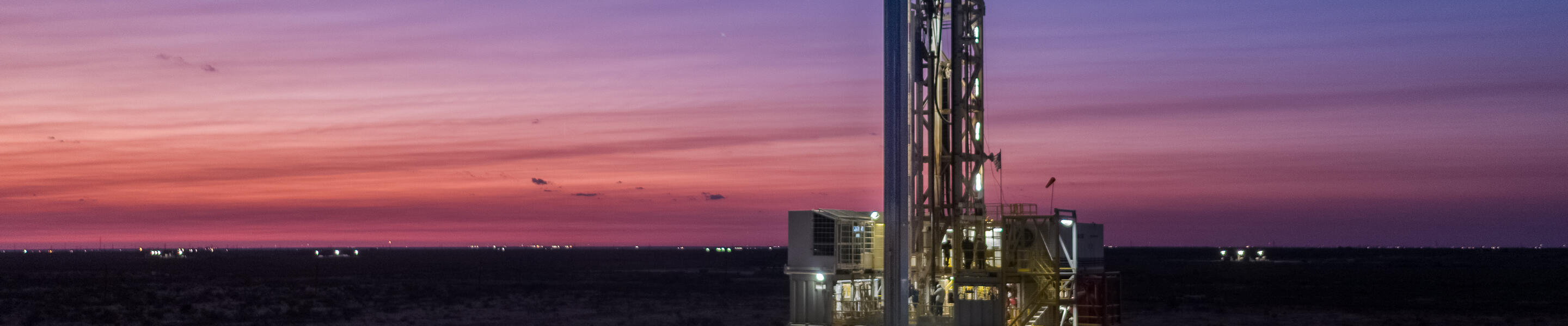 Drilling rig in the Permian basin at dusk.