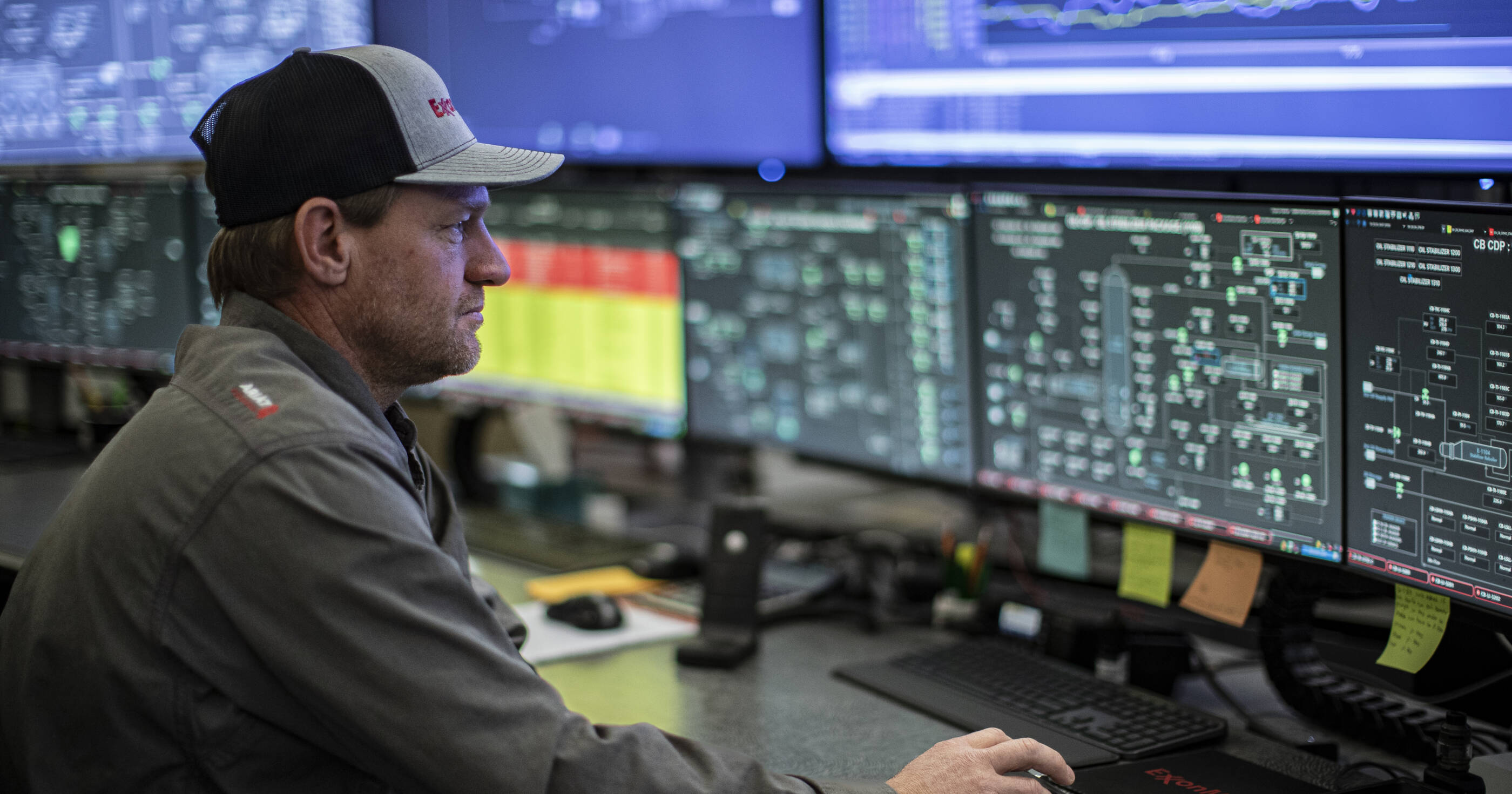 ExxonMobil employee working in front of monitors in the Permian Basin