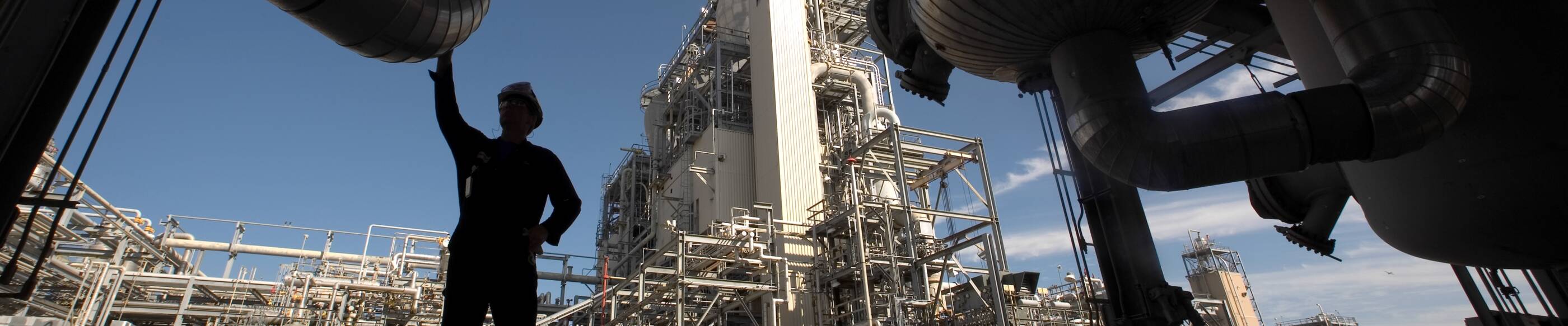 Silhouette of man standing under Mont Belview Chemical plant