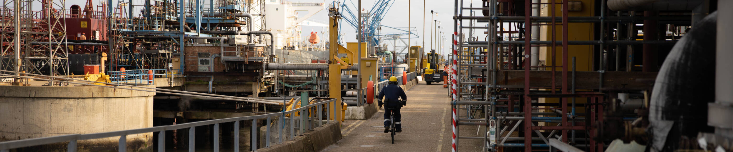 employee bicycling through complex