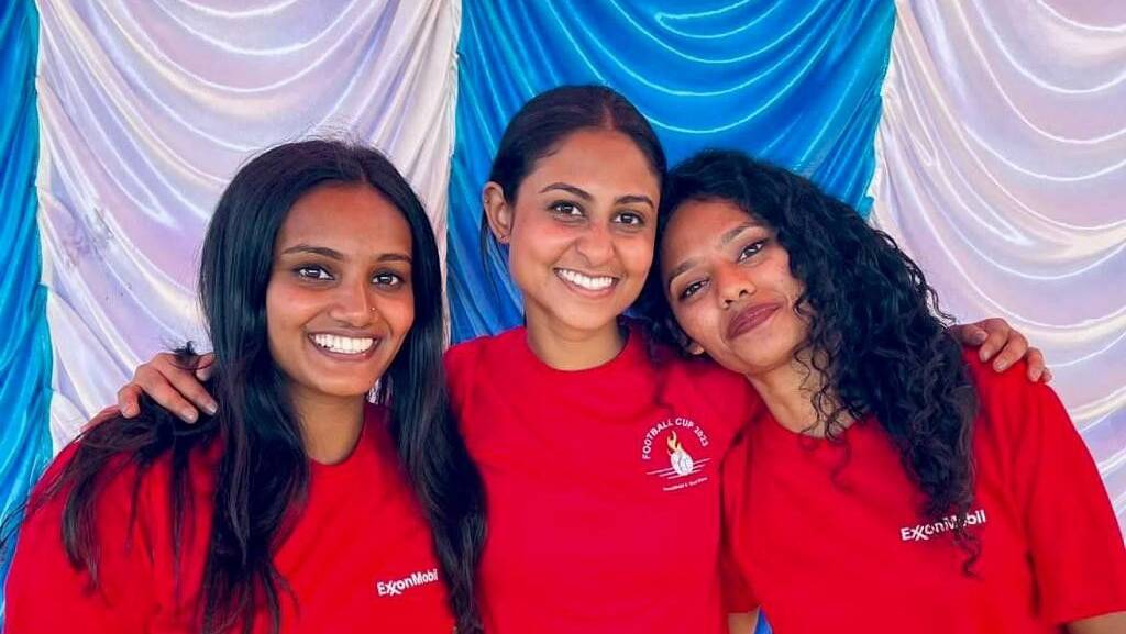 Three women smiling at the camera