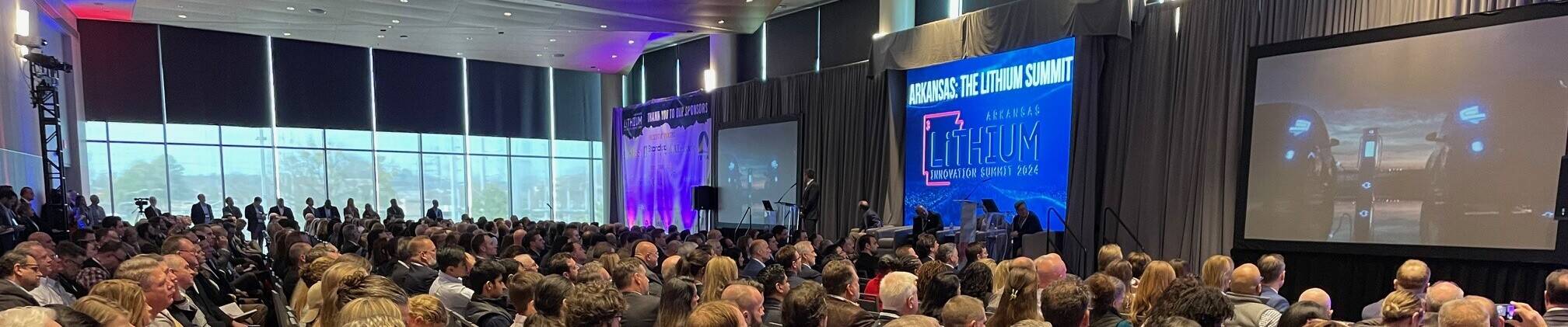 A large room with people watching a presentation