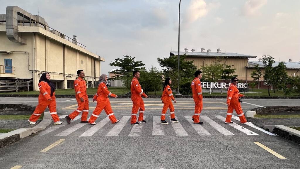 ExxonMobil employees crossing the street