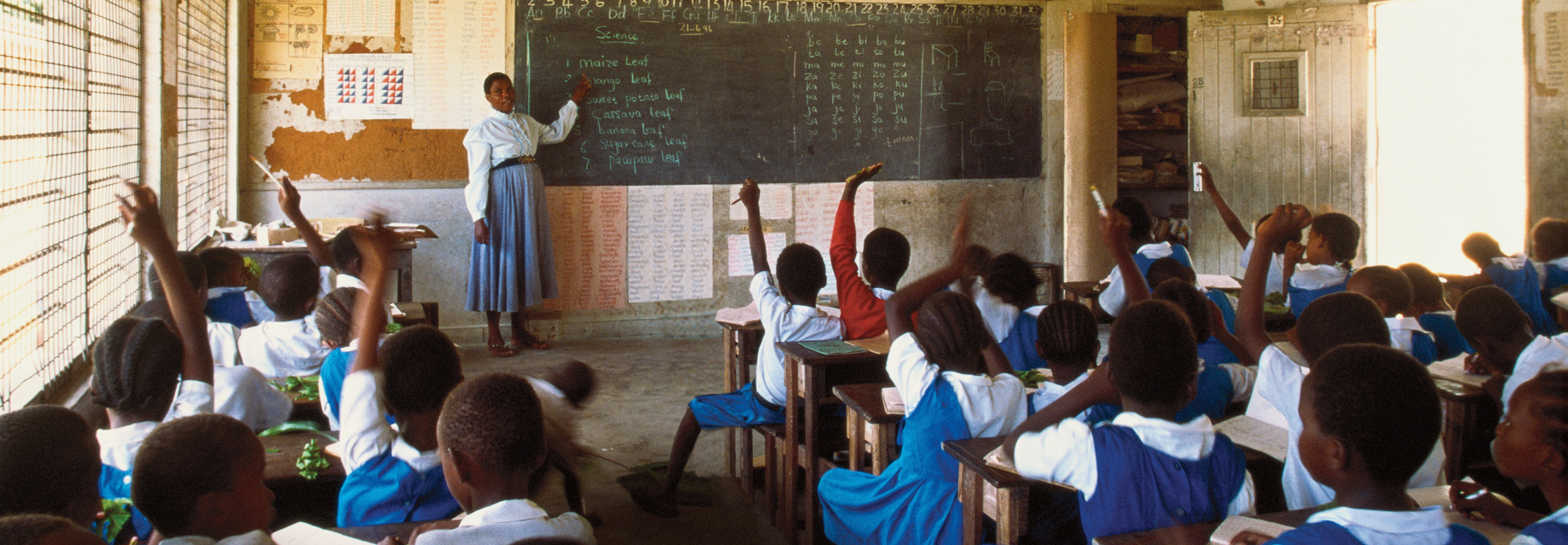Teacher in front of classroom.