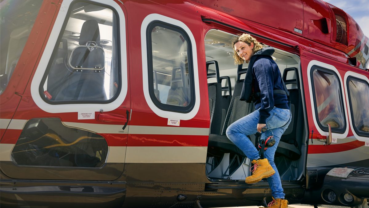 woman stepping in to helicopter