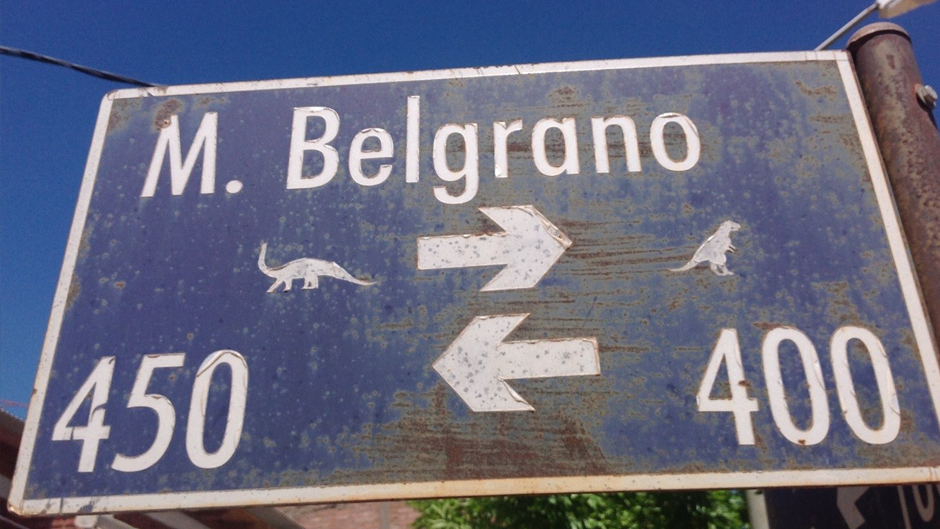 A sign in Argentina with dinosaurs on it
