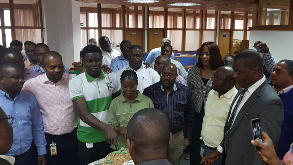 Mobil House personnel celebrate janitorial staff members.