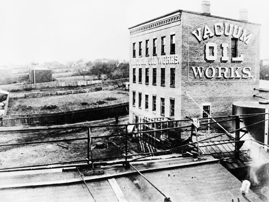 Black and white photo from 1879 showing the outside of the building of oil company Vacuum Oil Works