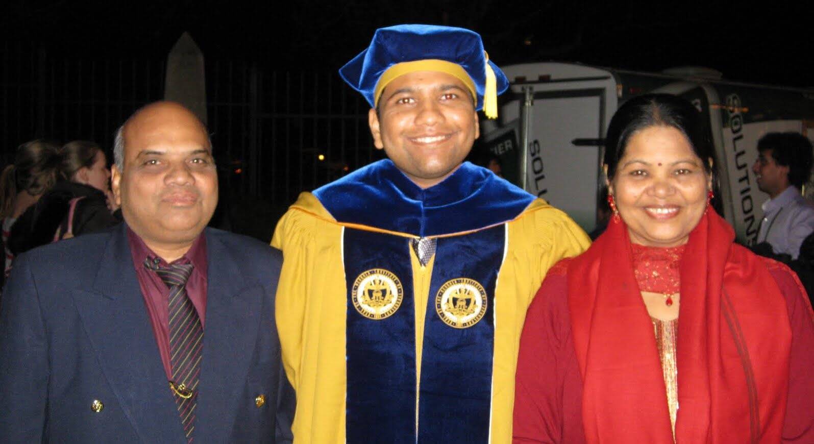 Dhaval Bhandari in a graduation cap and gown with his family