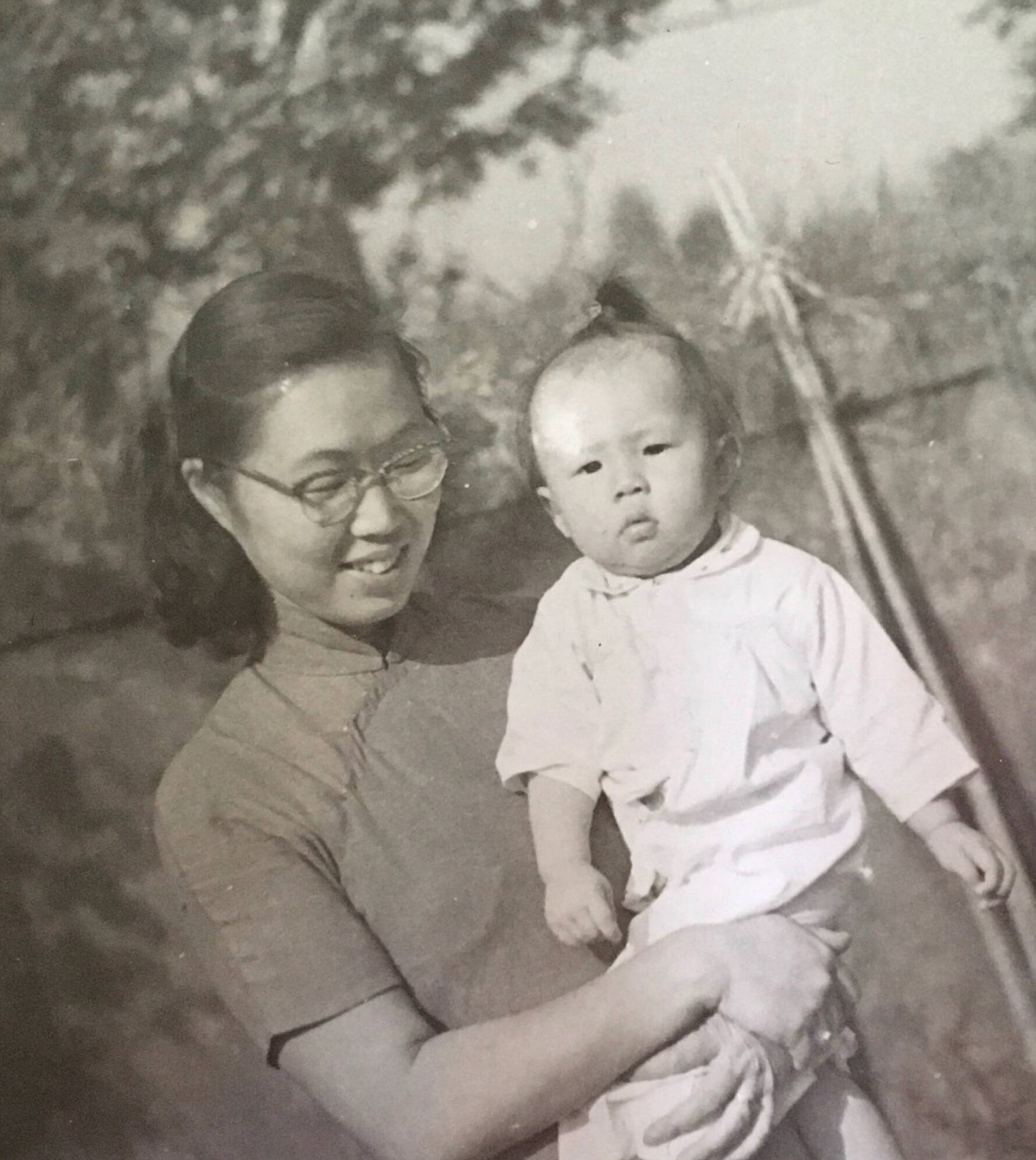 Old black and white photo of mom holding baby
