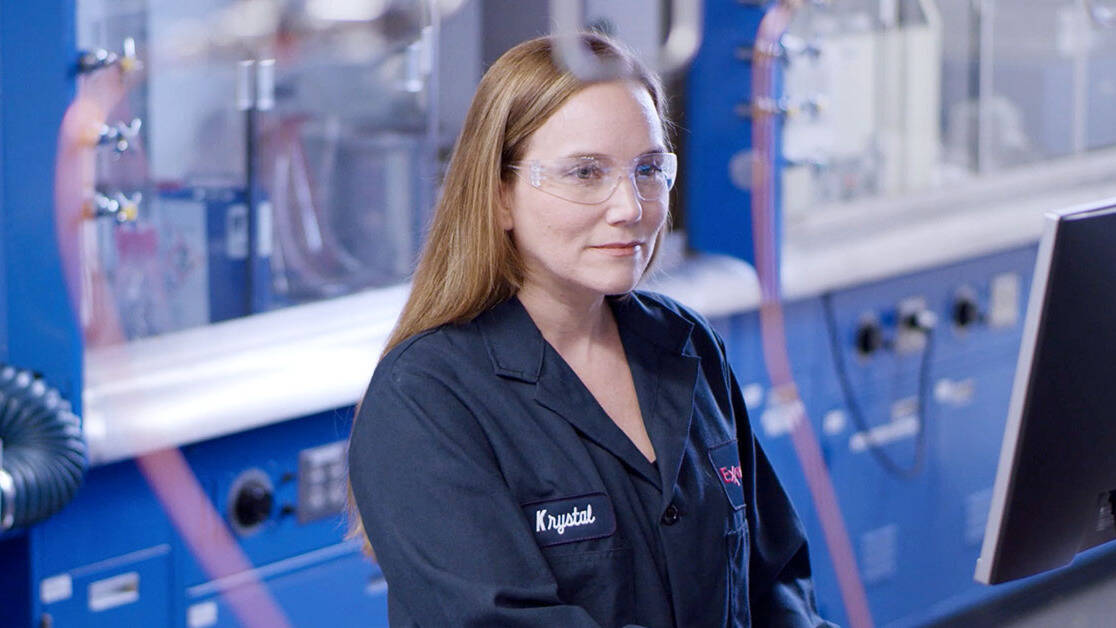 Women wearing a lab coat with safety goggles in lab
