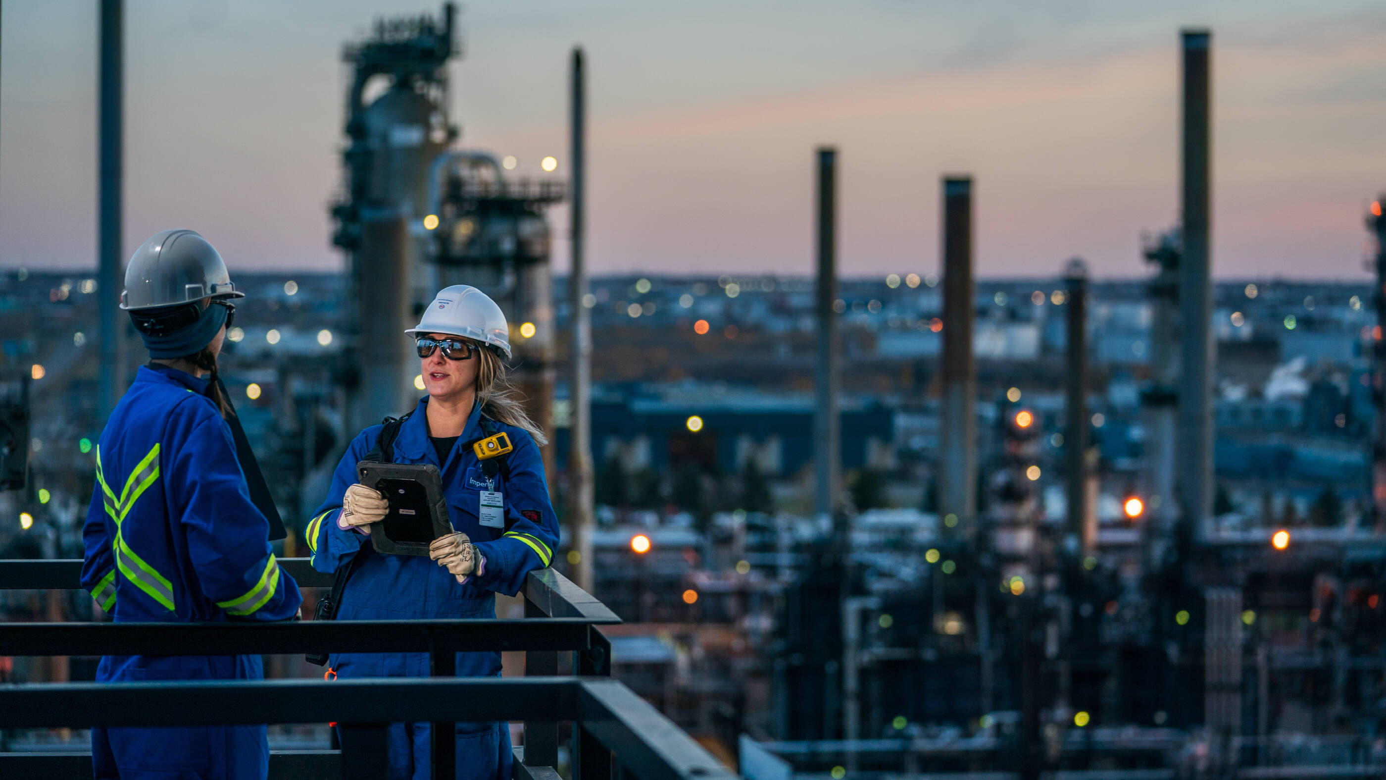 Two employees talk at the Strathcona Refinery.