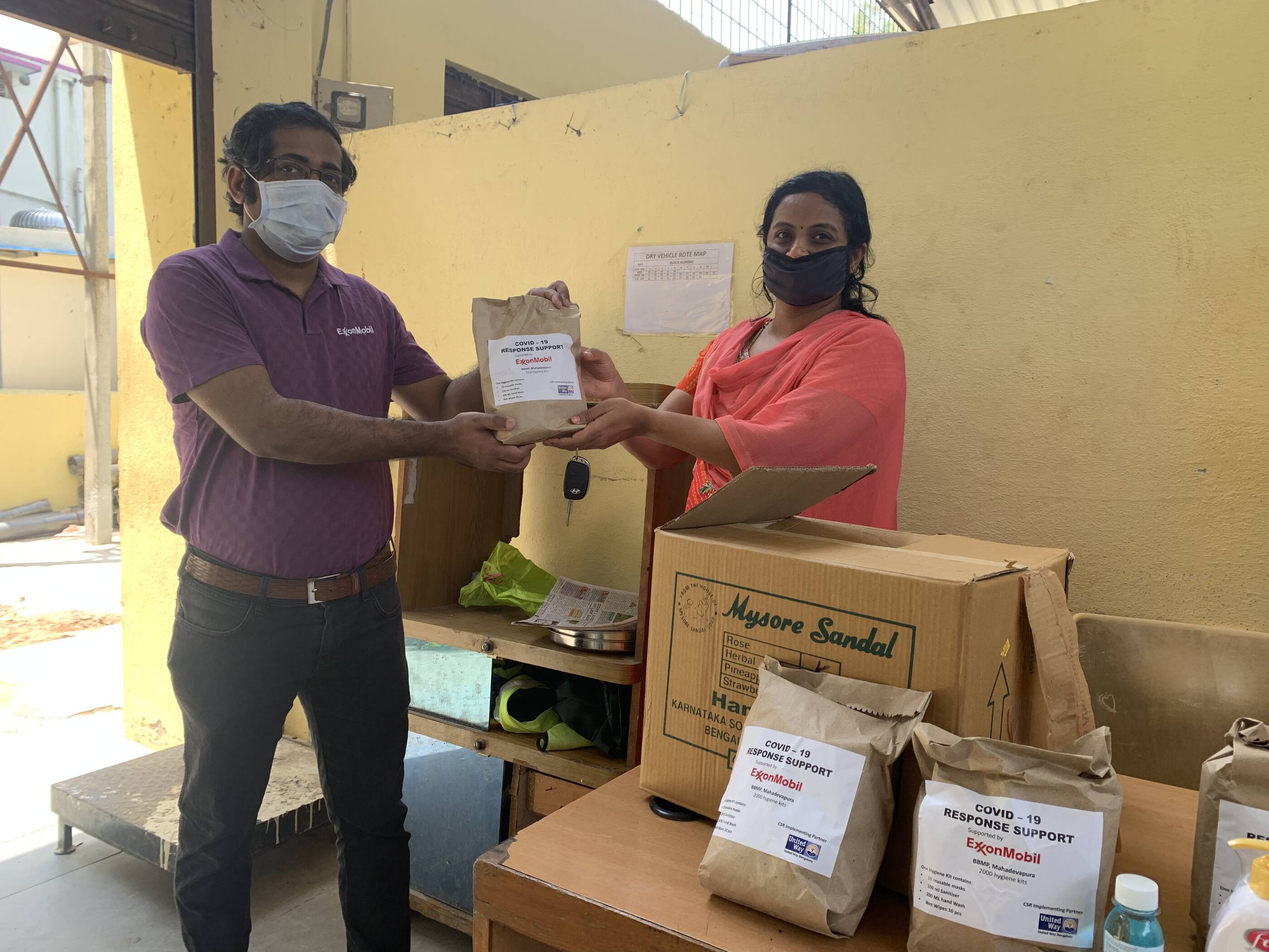 EM representative handing over hygiene kits to Mamatha Kumari, Executive Engineer, BBMP, Mahadevapura, Bengaluru
