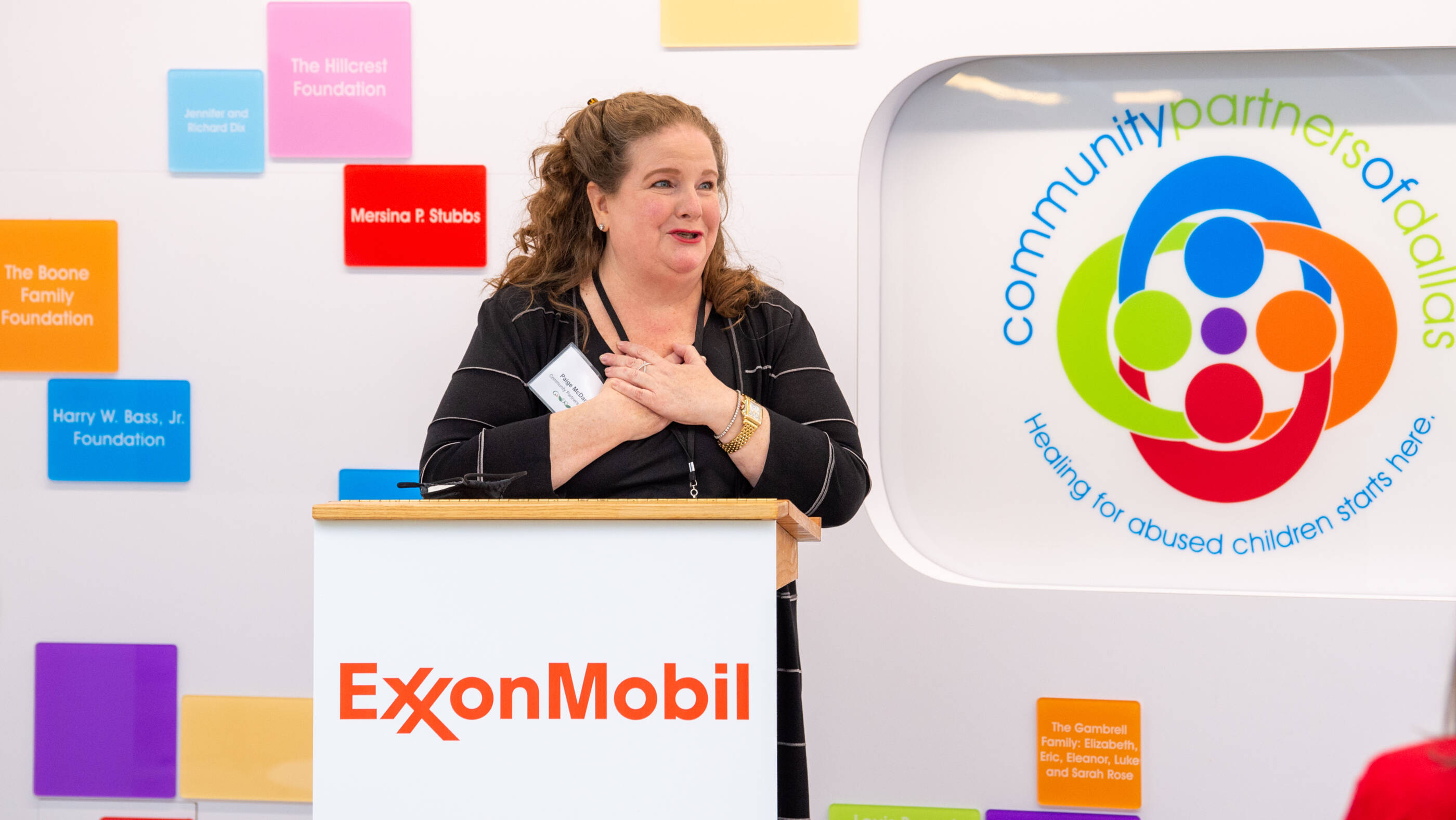 Paige McDaniel, president and chief executive officer of Community Partners of Dallas, recognizes ExxonMobil for its $50,000 holiday gift.